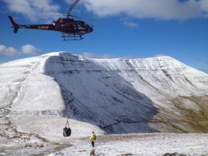 A helicopter airlifts materials to repair footpaths onto Fan y Big, one of the peaks in the central Beacons - photo credit - Sam Harpur