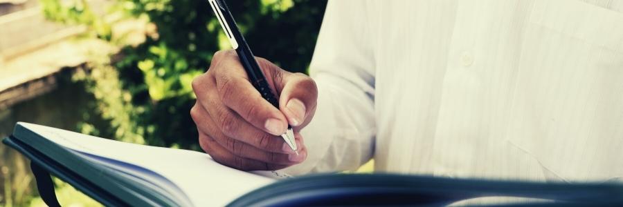 Man writes in notebook